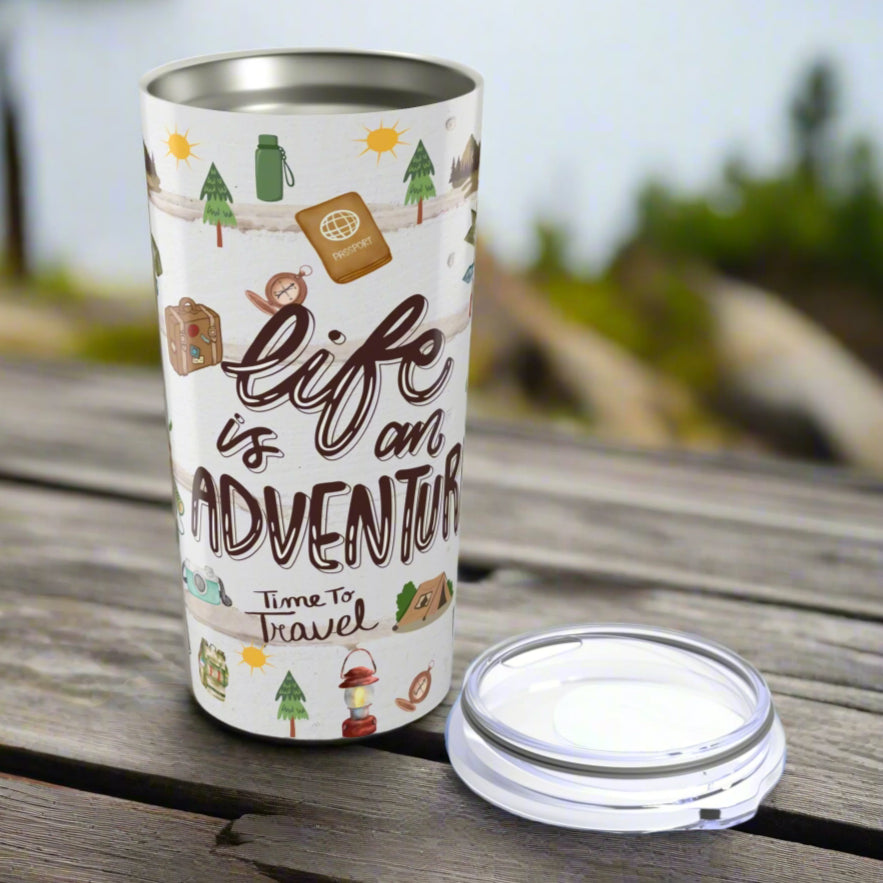 Front view of 20oz stainless steel tumbler with “Life is an Adventure” text and wraparound print featuring tents, compass, trees, sun, lantern, and camping icons.