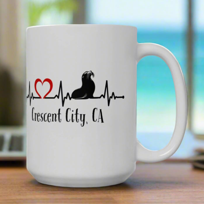 White mug with a design of a heartline with sea lion and heart.