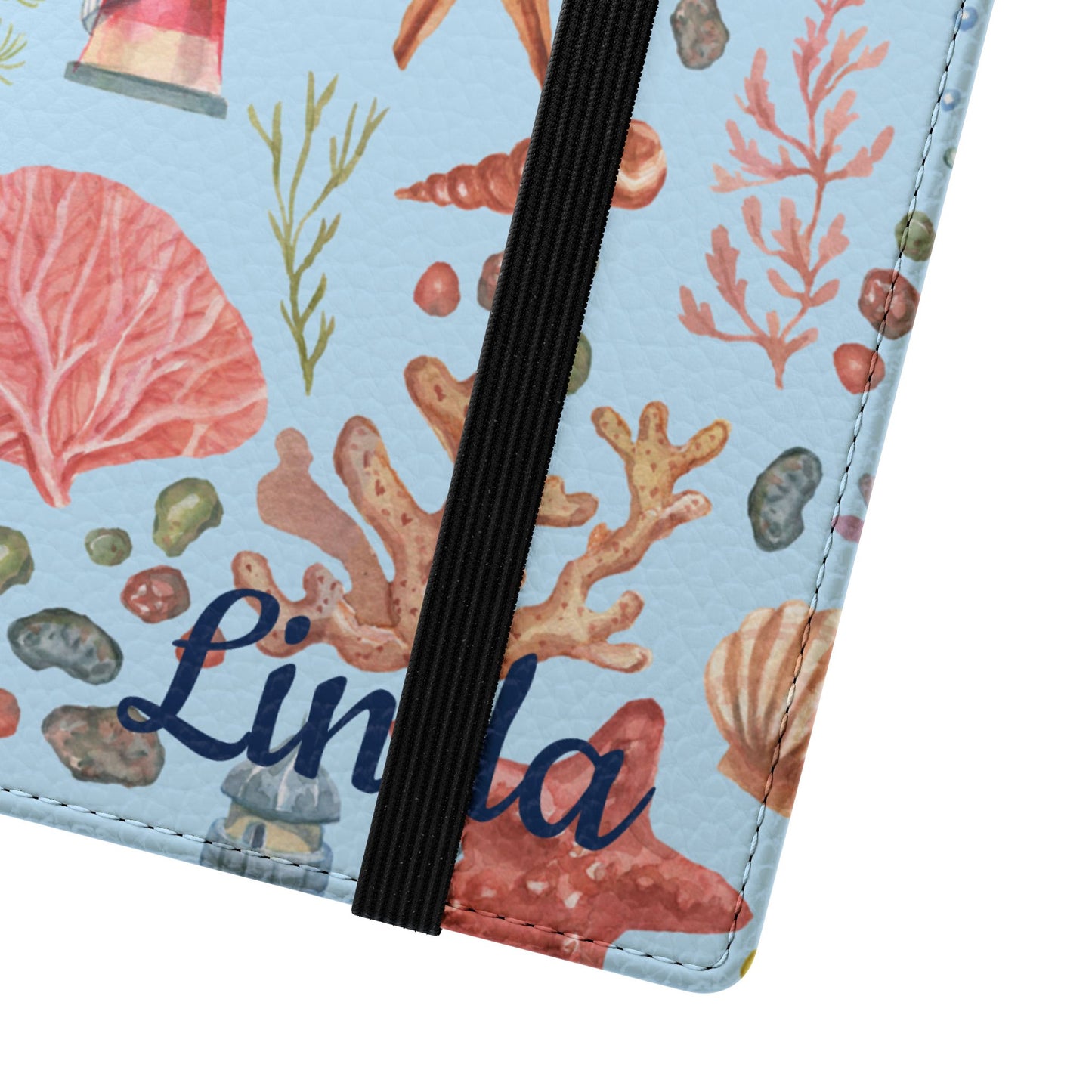 Close-up of a flip phone case with a sea-themed cover featuring corals, shells, and personalized name on a light blue background.