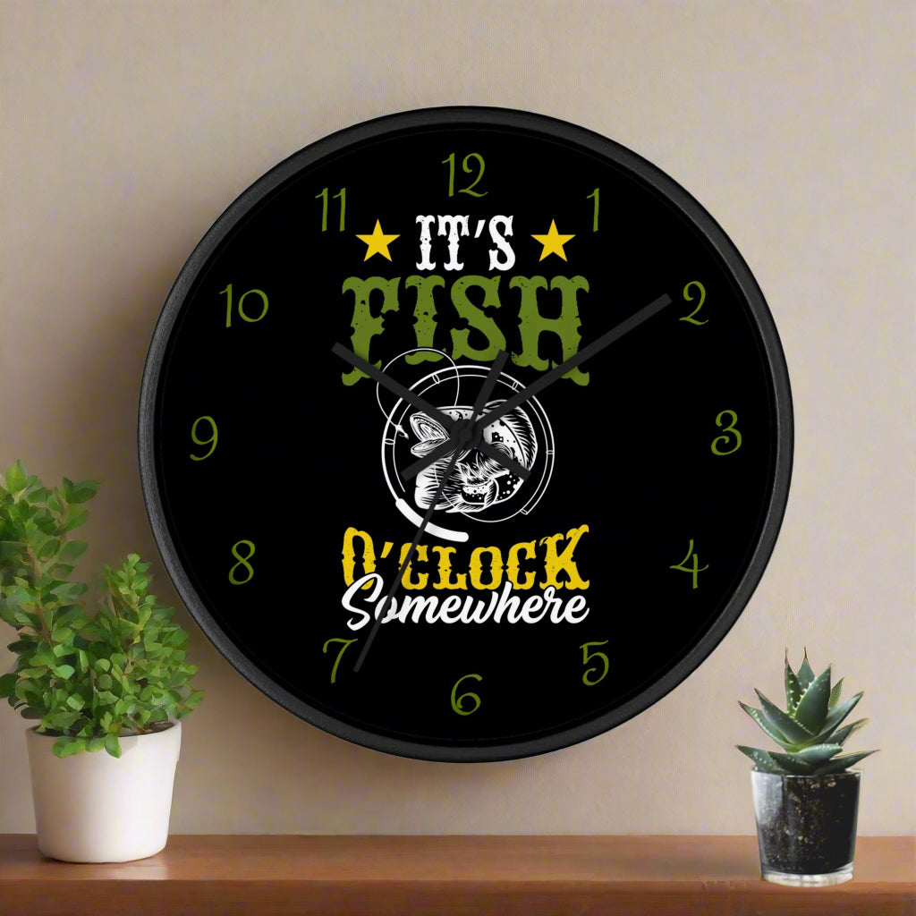Wall clock with fishing-themed design on a white wall with a plant and small pot.