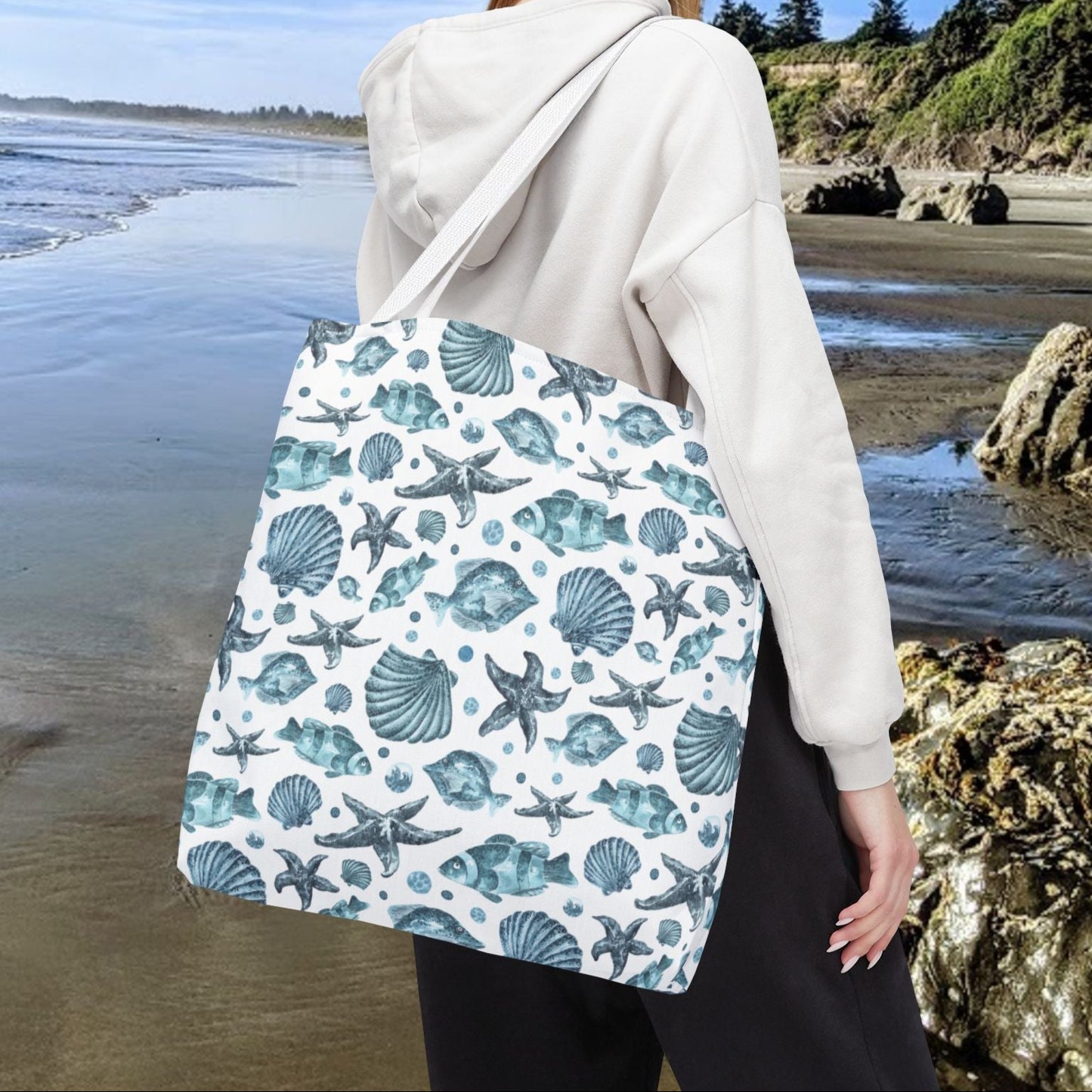 18" x 18" Tote bag with white strap and an all-over blue seashell, starfish, and fish pattern on a white background with white handles.