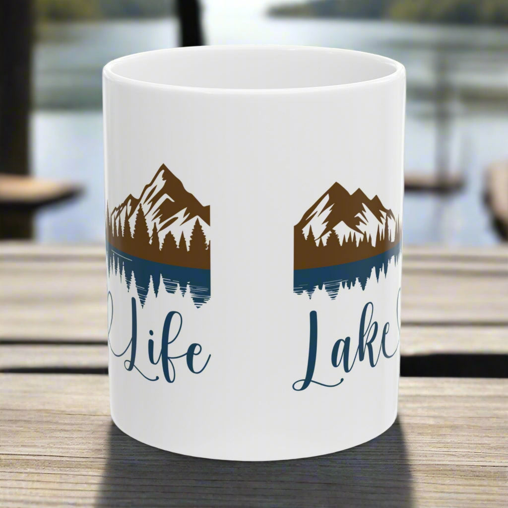 Side view of our white 11 oz. ceramic mug with mountain and lake reflection design, featuring the phrase “Lake Life” – perfect for nature lovers.