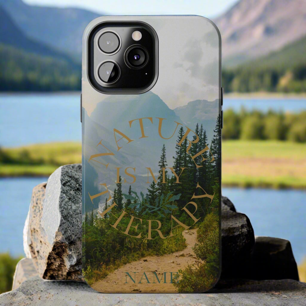 Phone case with nature design and text 'Nature is my therapy' on a gray background