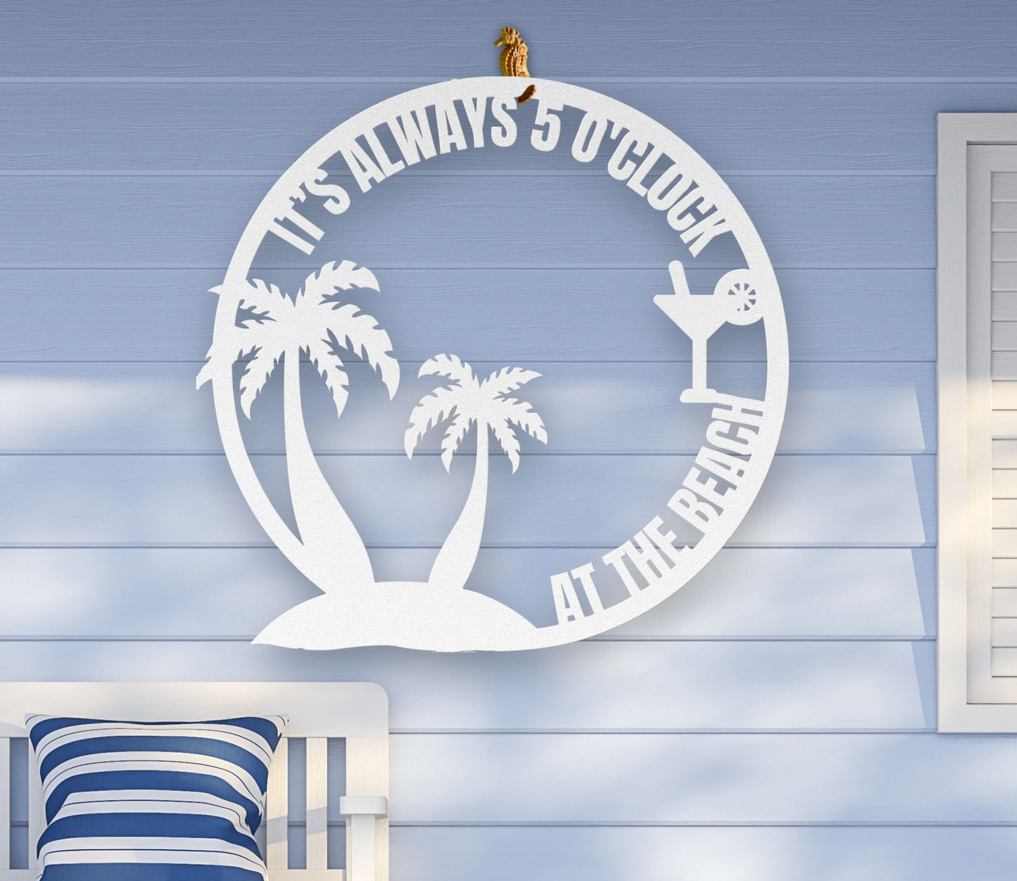 White metal wall art featuring palm trees and a cocktail glass with the phrase "It’s 5 0’Clock Beach" in a playful beach theme, available in 6 sizes.