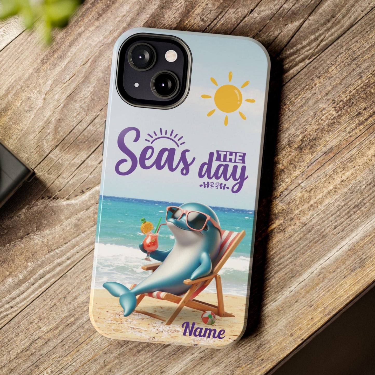 Seas the Day dolphin-themed phone case with personalized name, glossy finish, and beach-inspired design with a dolphin enjoying a cocktail during a sunny day on the beach with the phrase Seas the Day.