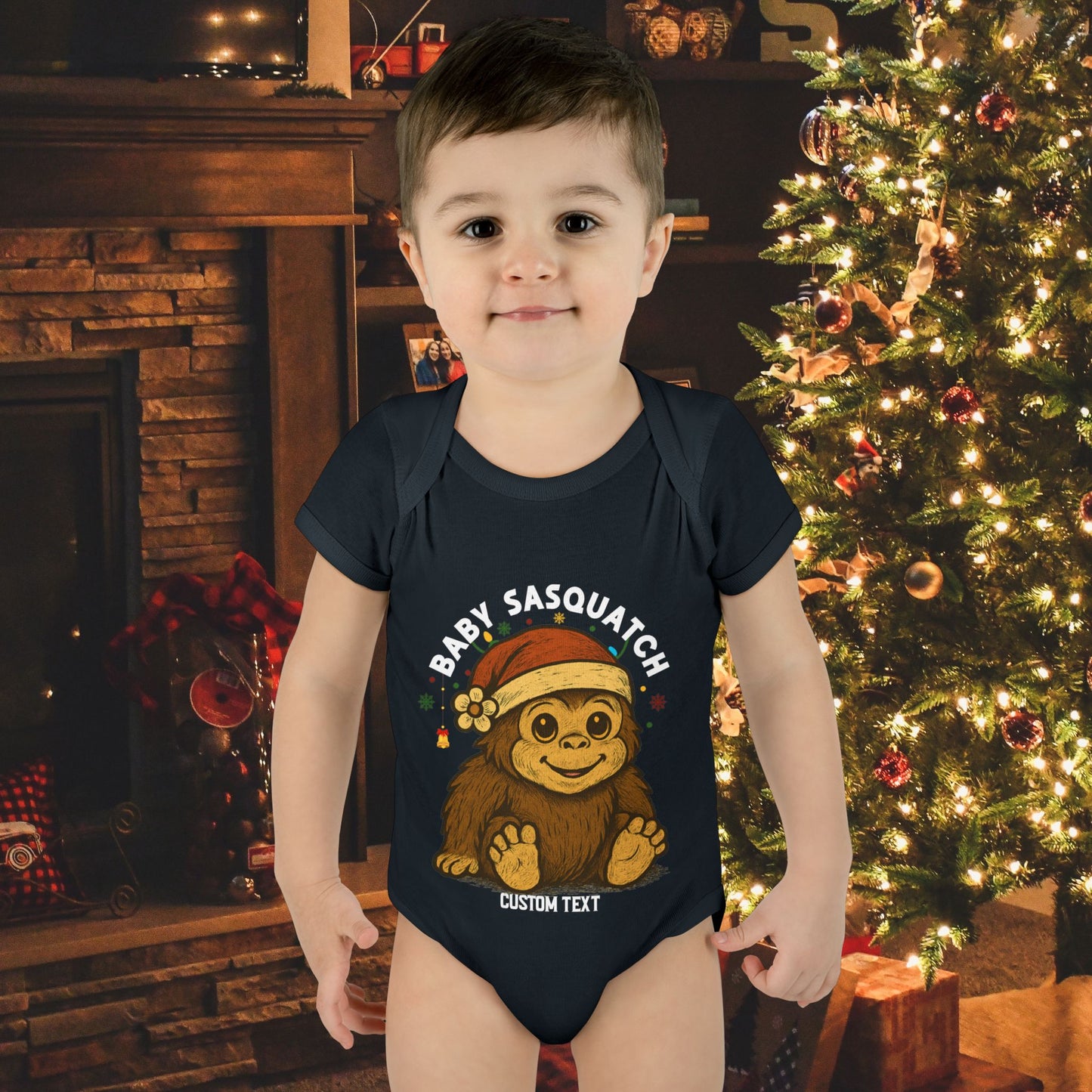 Child wearing a 'Baby Sasquatch' onesie with custom text.