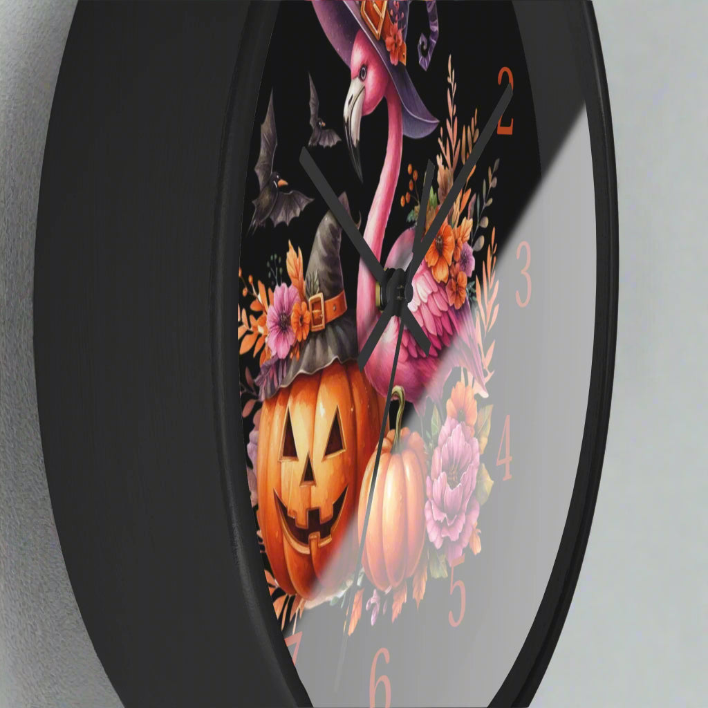 Halloween-themed clock with a pink flamingo, pumpkins, and flowers on a black background.