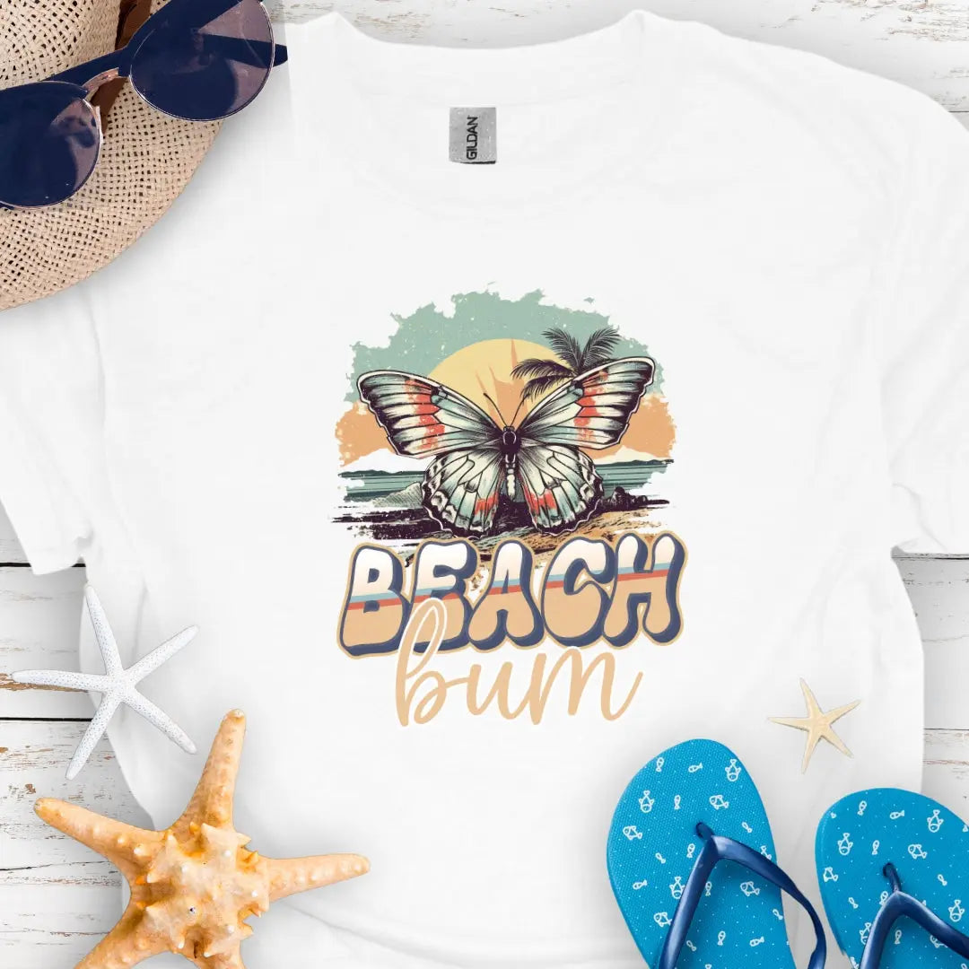 White t-shirt with butterfly in sunset with text Beach Bum.