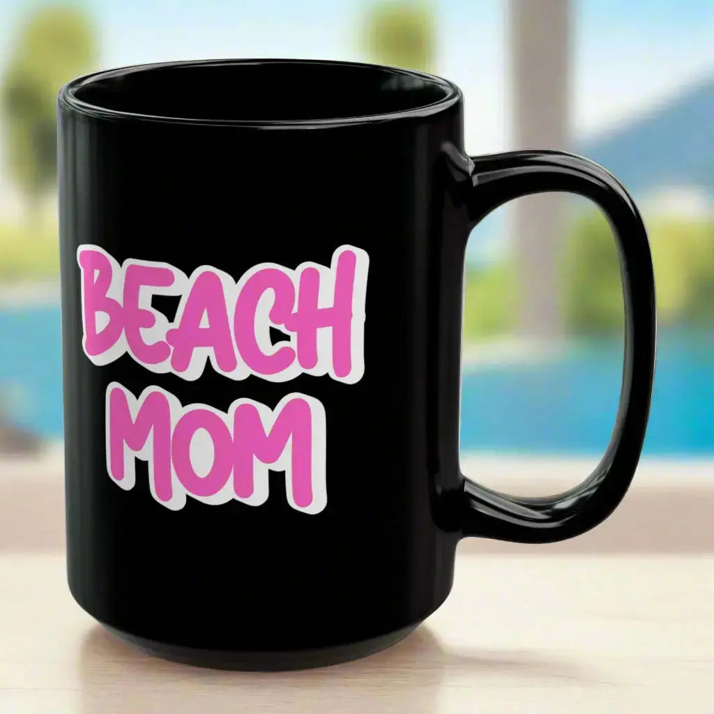 Black 15 oz mug with a bright hot pink with white outline text Beach Mom.