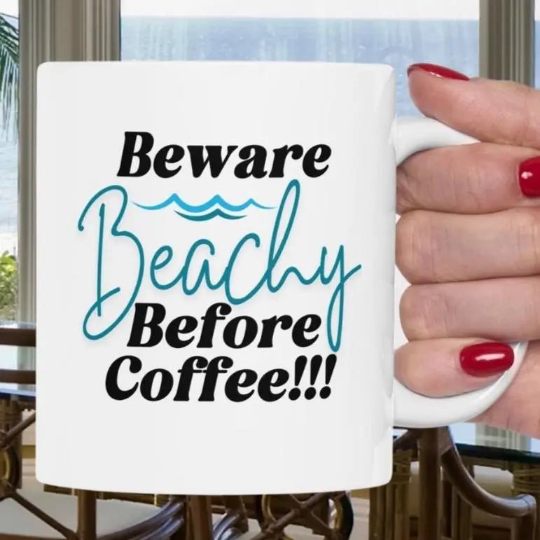 White coffee mug that says Beware Beachy Before coffee with wave image.