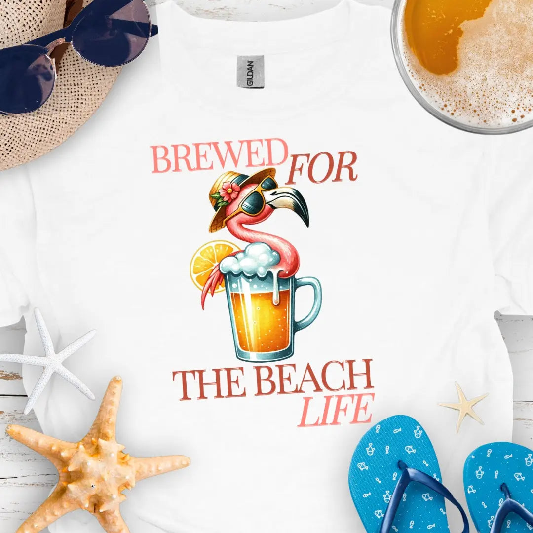 White t-shirt with beer and flamingo that says Brewed for the Beach Life.