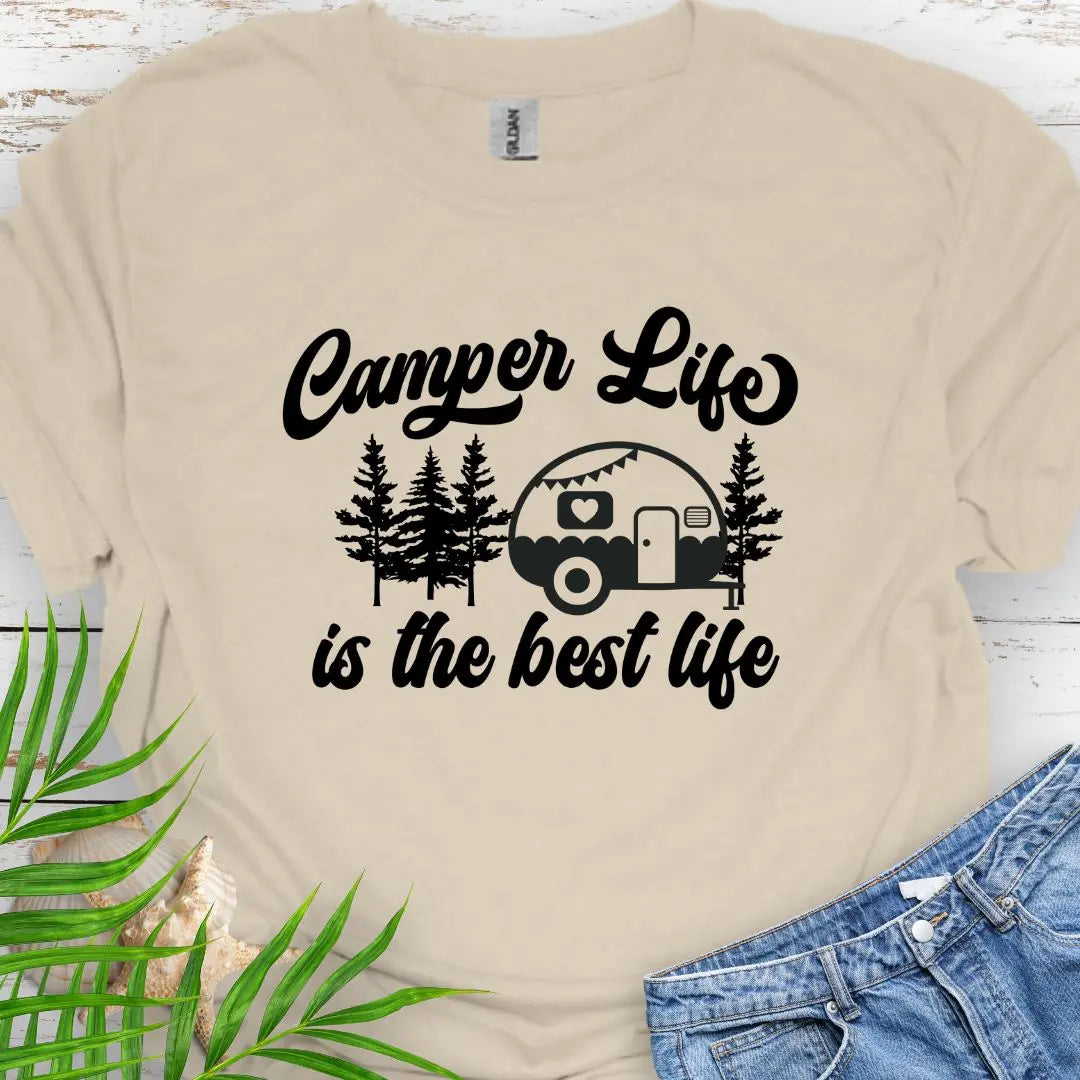 A cute vintage camper among the forest that says Camper Life is the good life in Natural.