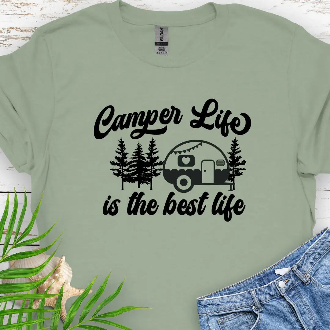 A cute vintage camper among the forest that says Camper Life is the good life in Sage.