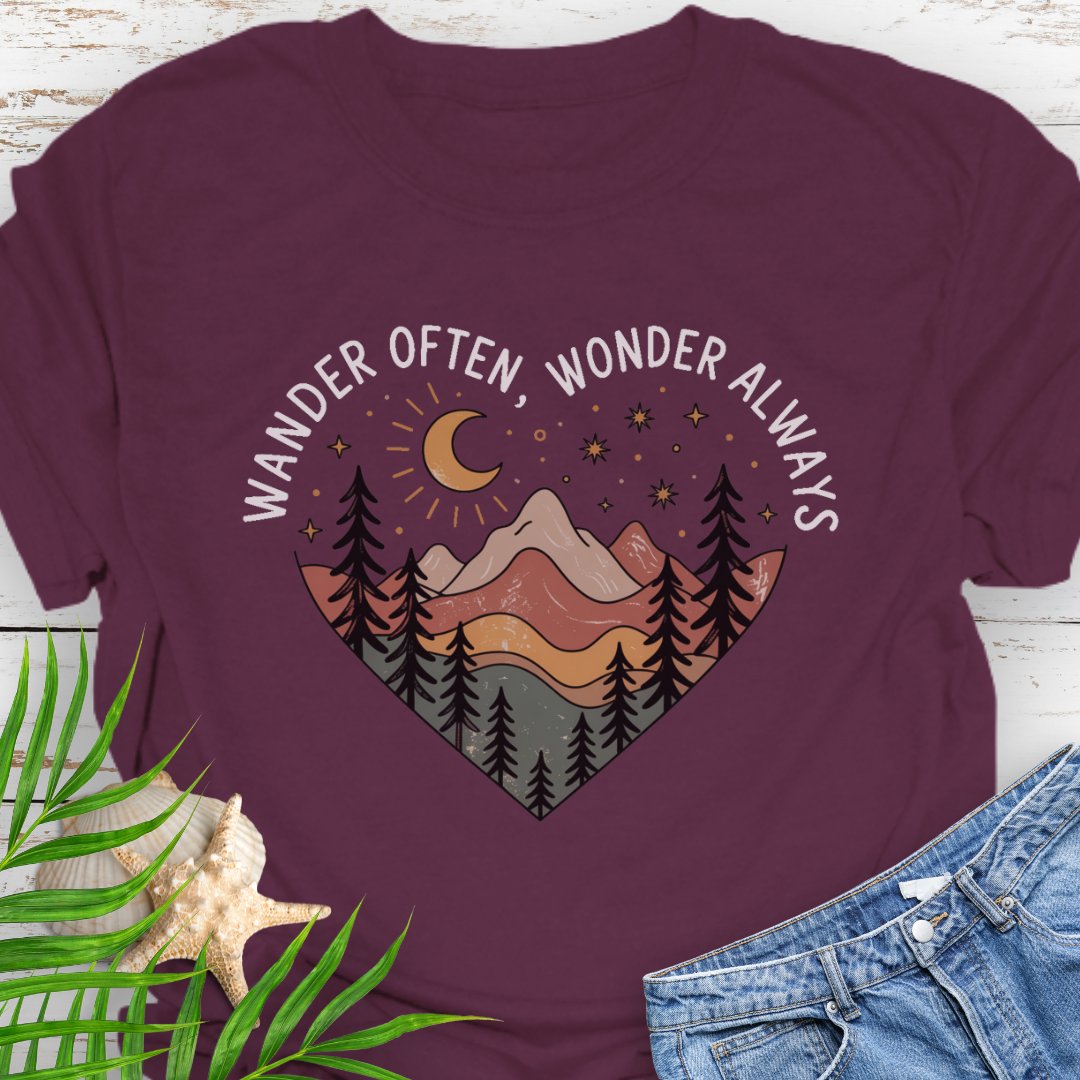 Maroon Unisex t-shirt with mountain and trees in a heart shape and the phrase "Wander Often, Wonder Always".