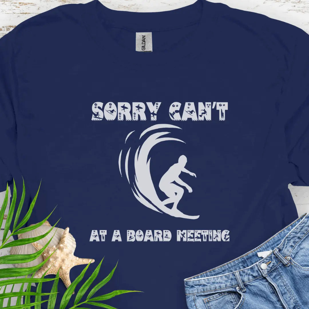 Navy t-shirt with a surfer and says Sorry Can't Board Meeting - ideal for beach vacations, casual Fridays, and surfing enthusiasts.