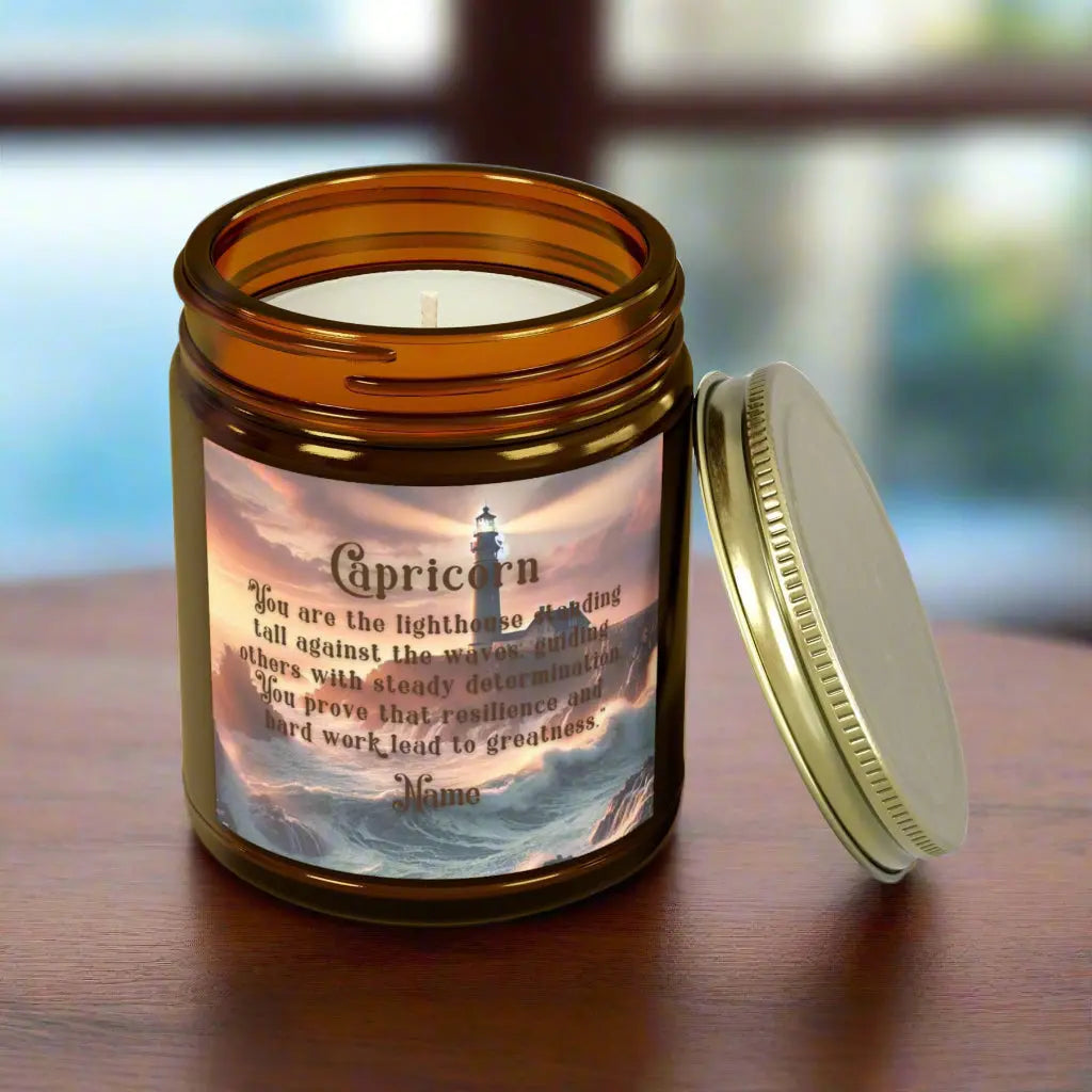 Elegant Capricorn Zodiac hand-poured coconut apricot wax scented candle in a 9 oz amber glass jar with gold lid, featuring a picture of crashing waves onto a lighthouse with an inspirational quote personalized. A beach-inspired astrology gift, perfect for relaxation and decor.