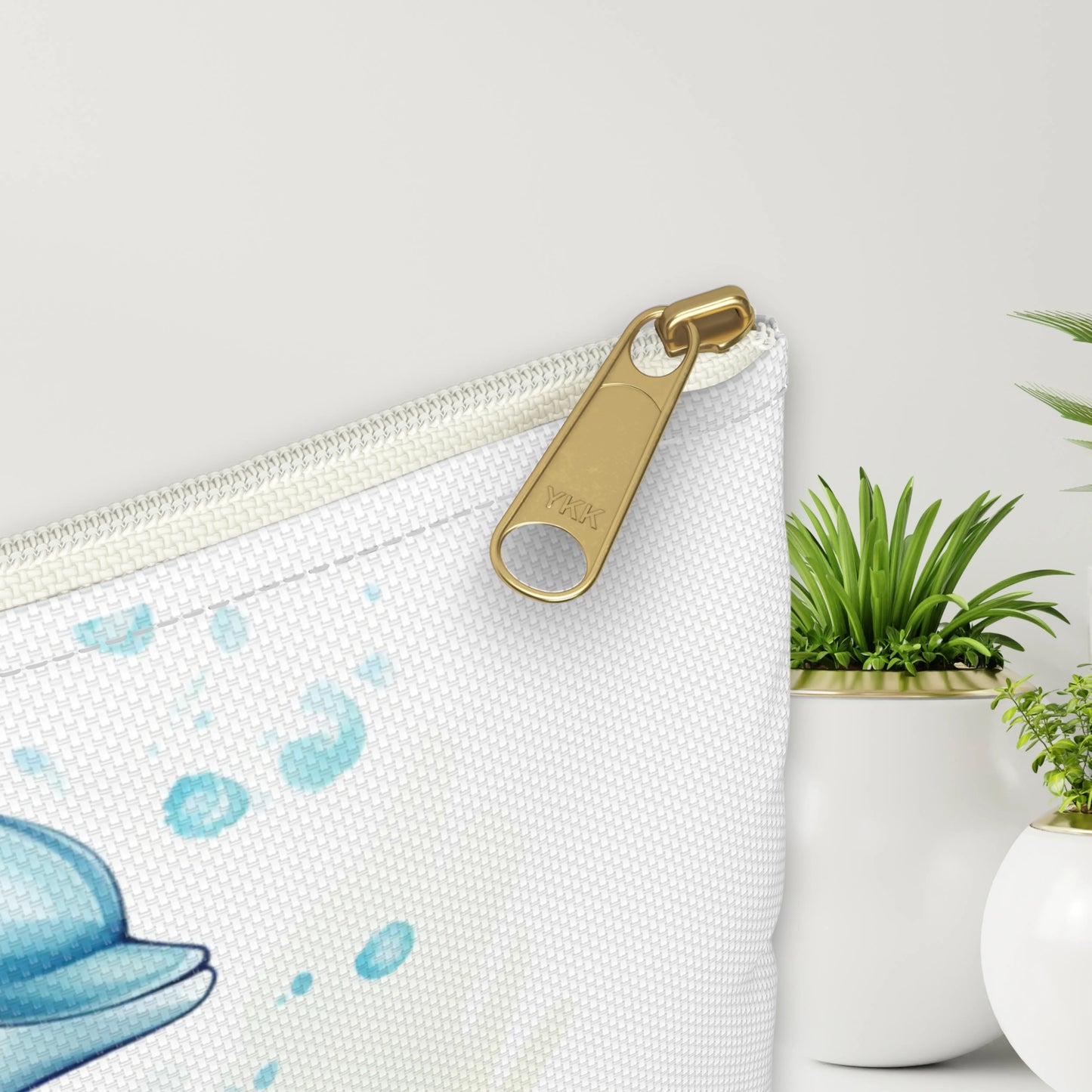 Close up view of our Dancing Dolphins Accessory Pouch constructed from a durable material with a zipper closure featuring two dolphins splashing out of the water on a white background. Available in small or large.