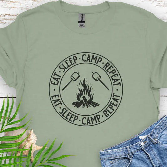 A campfire with two smore sticks that says Eat Sleep Camp Repeat in a circle around the campfire graphic in Sage.