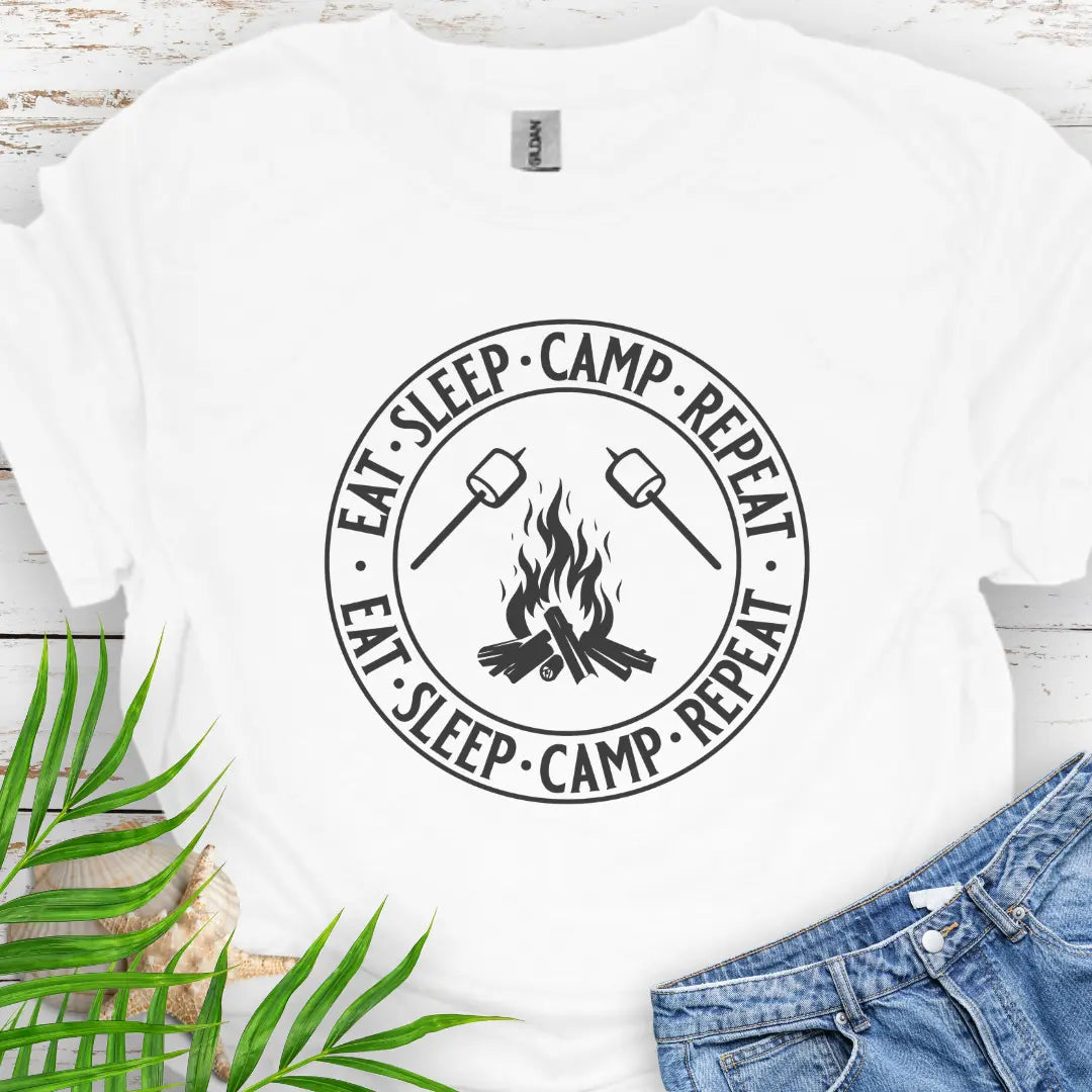 A campfire with two smore sticks that says Eat Sleep Camp Repeat in a circle around the campfire graphic in White.