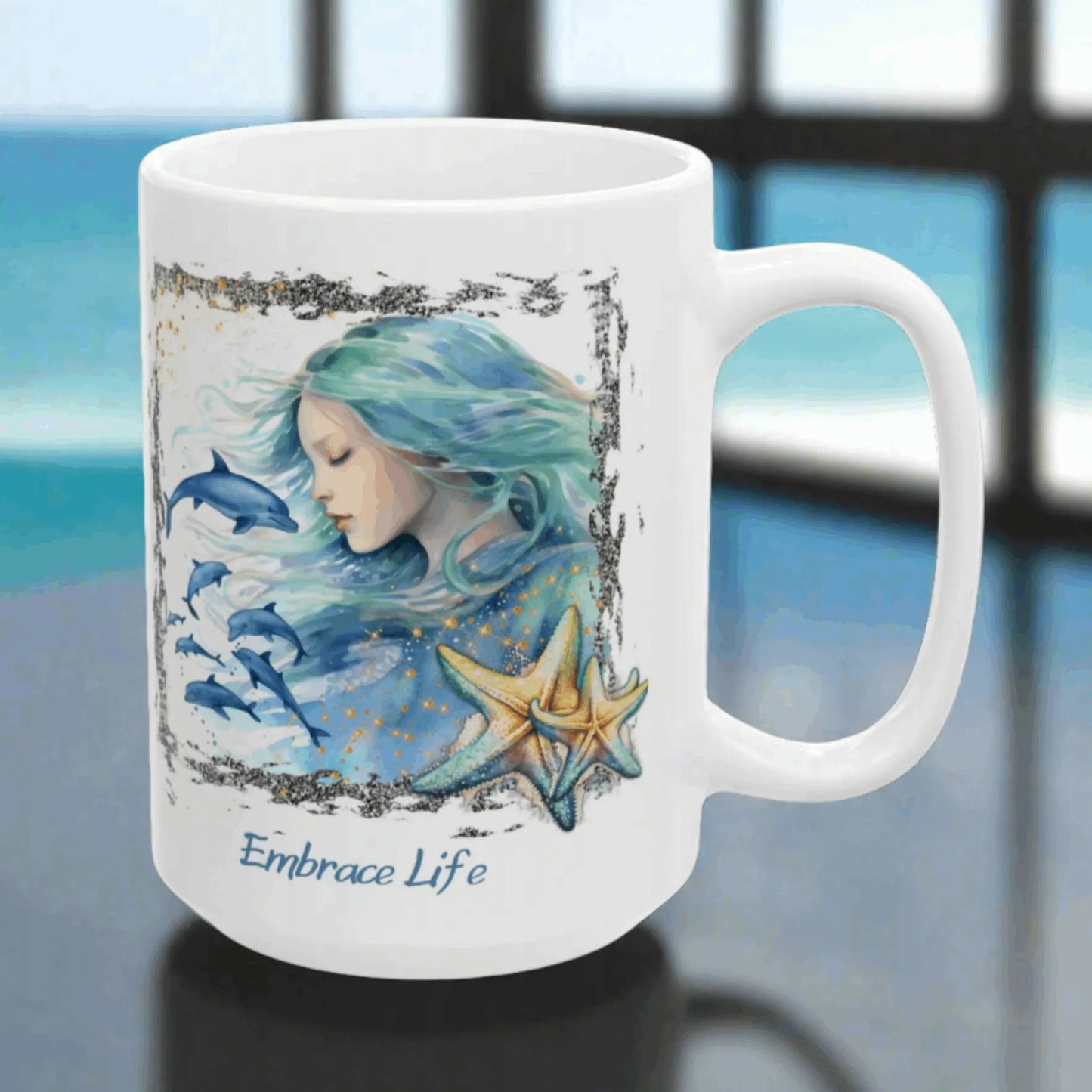 White 15 oz Ceramic Mug with a mermaid and swimming dolphins gives a mystical and positive vibe with the text Embrace Life - ideal for those who love the beach and marine life!