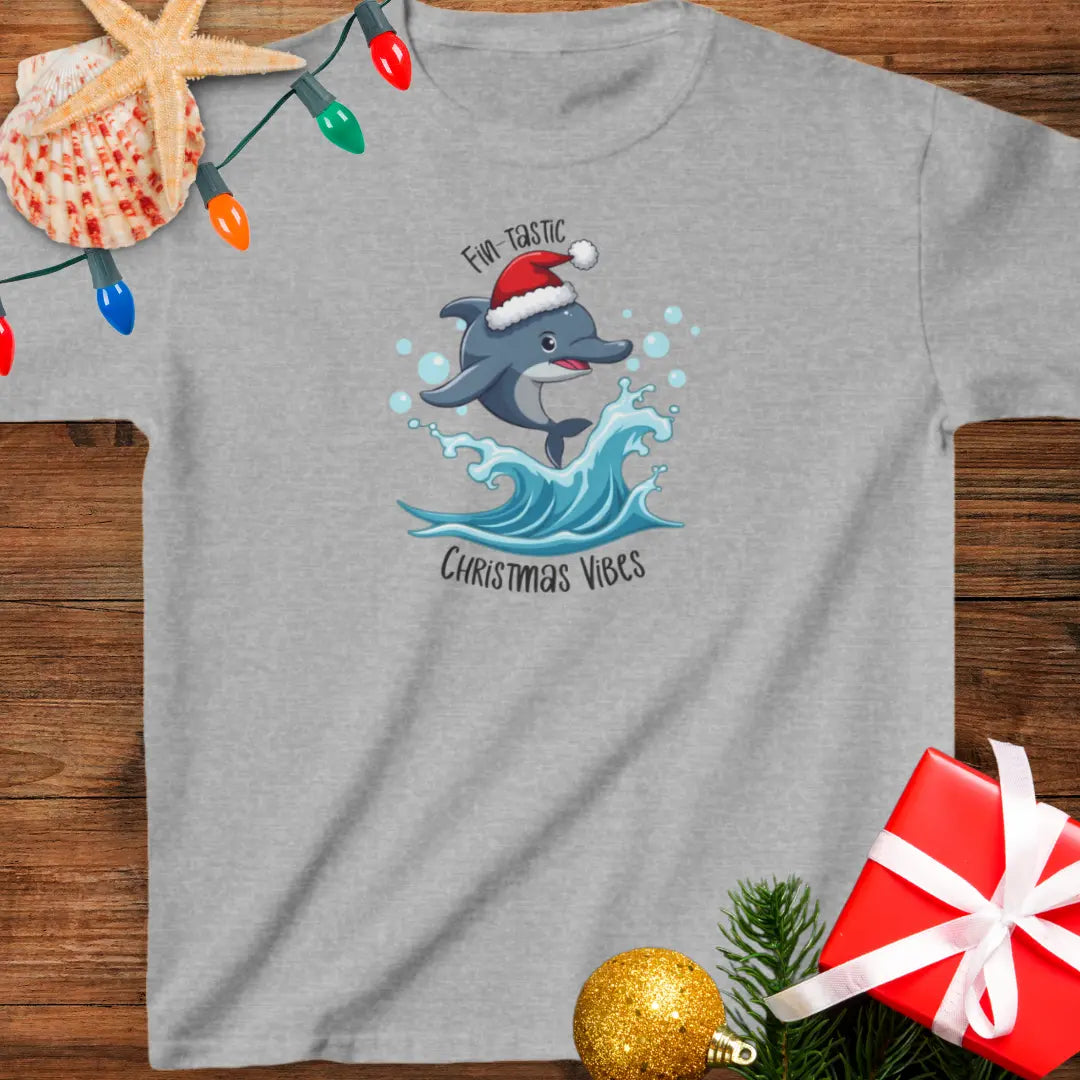 Sport Gray youth t-shirt with dolphin wearing a Santa hat jumping over a wave and text “Fin-tastic Christmas Vibes”.