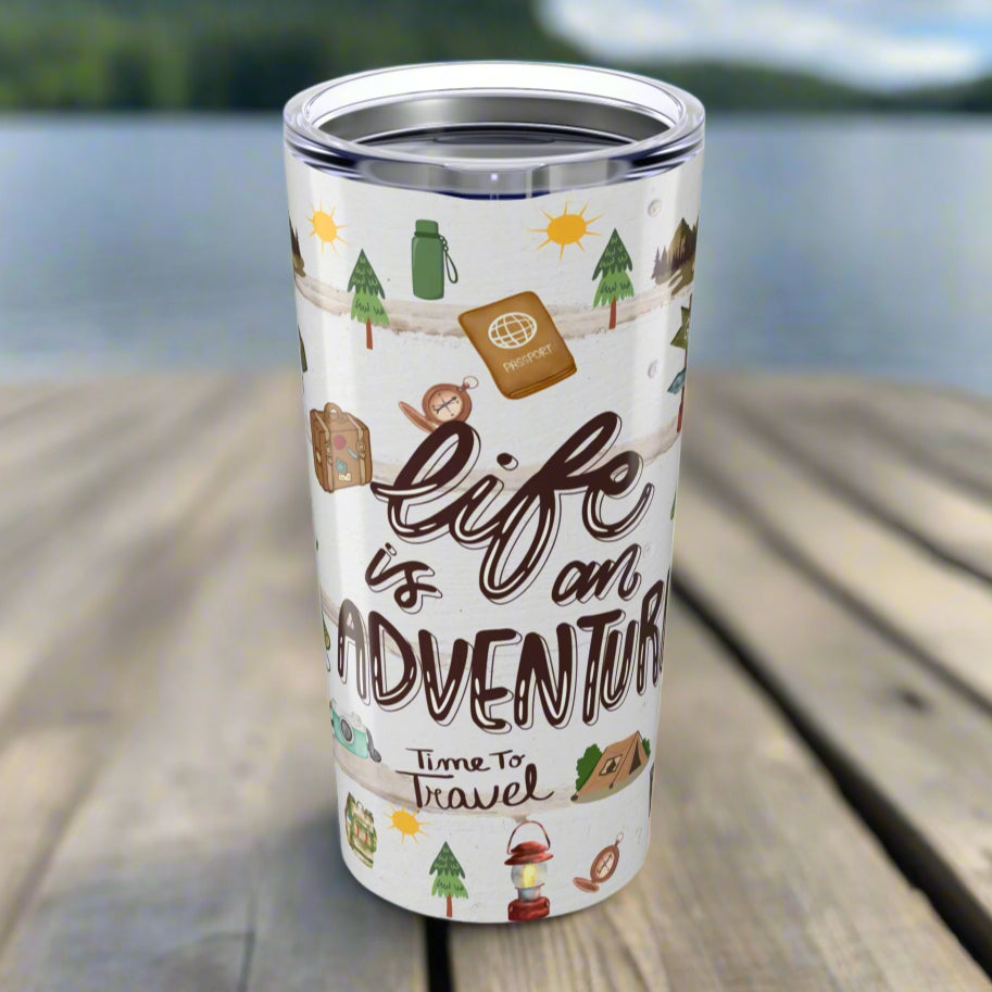 20oz stainless steel tumbler with “Life is an Adventure” text and wraparound print featuring tents, compass, trees, sun, lantern, and camping icons.