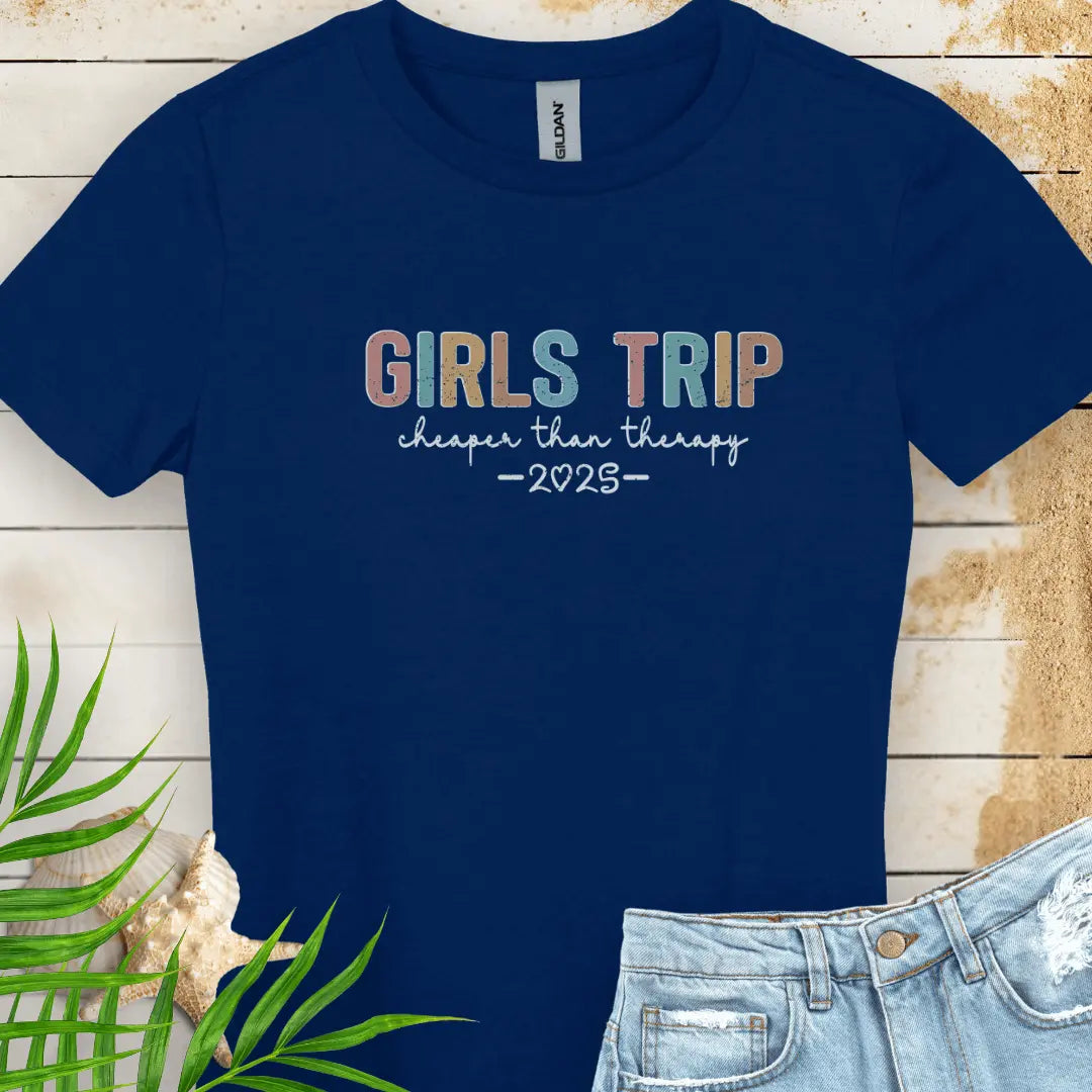 Navy Women's T-shirt featuring the phrase 'Girl’s Trip Cheaper Than Therapy' customized with the year. Made from soft, breathable fabric, this stylish and fun tee is perfect for group vacations, bachelorette parties, and beach getaways.