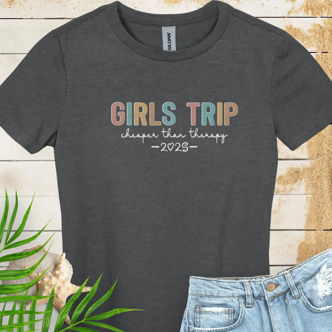 Dark Heather Women's T-shirt featuring the phrase 'Girl’s Trip Cheaper Than Therapy' customized with the year. Made from soft, breathable fabric, this stylish and fun tee is perfect for group vacations, bachelorette parties, and beach getaways.