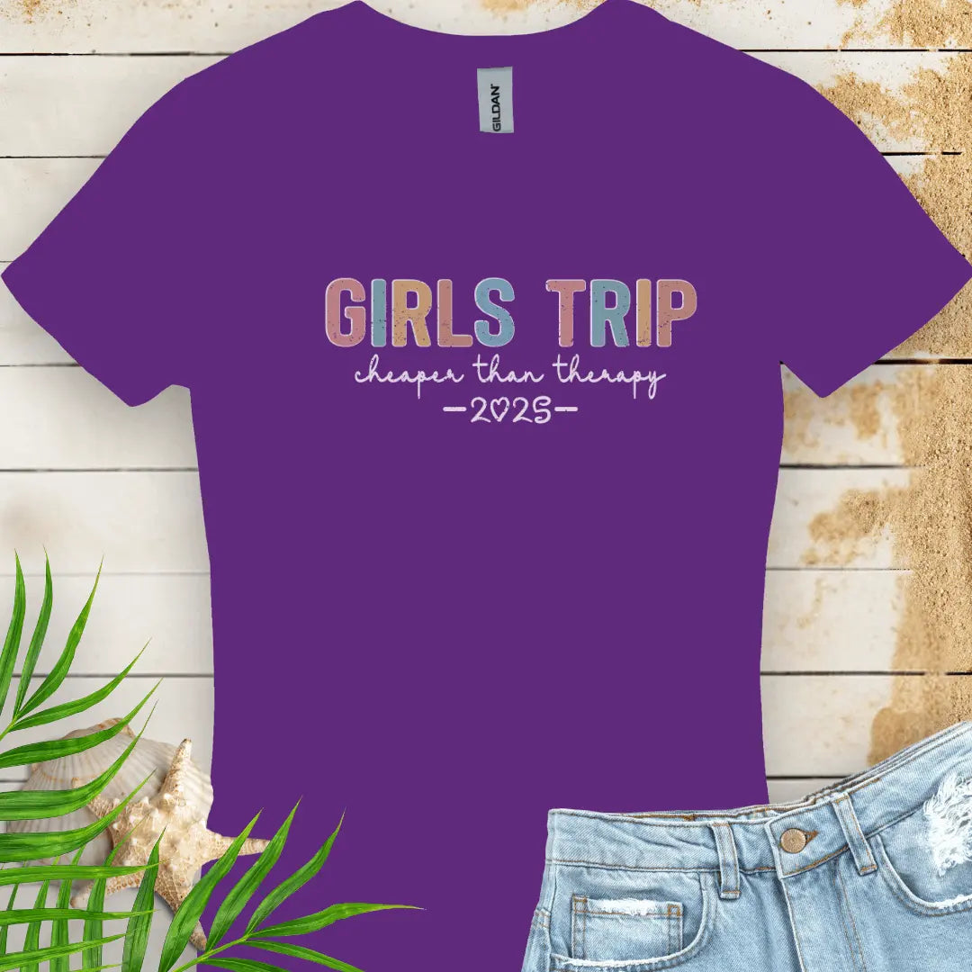 Purple Women's T-shirt featuring the phrase 'Girl’s Trip Cheaper Than Therapy' customized with the year. Made from soft, breathable fabric, this stylish and fun tee is perfect for group vacations, bachelorette parties, and beach getaways.
