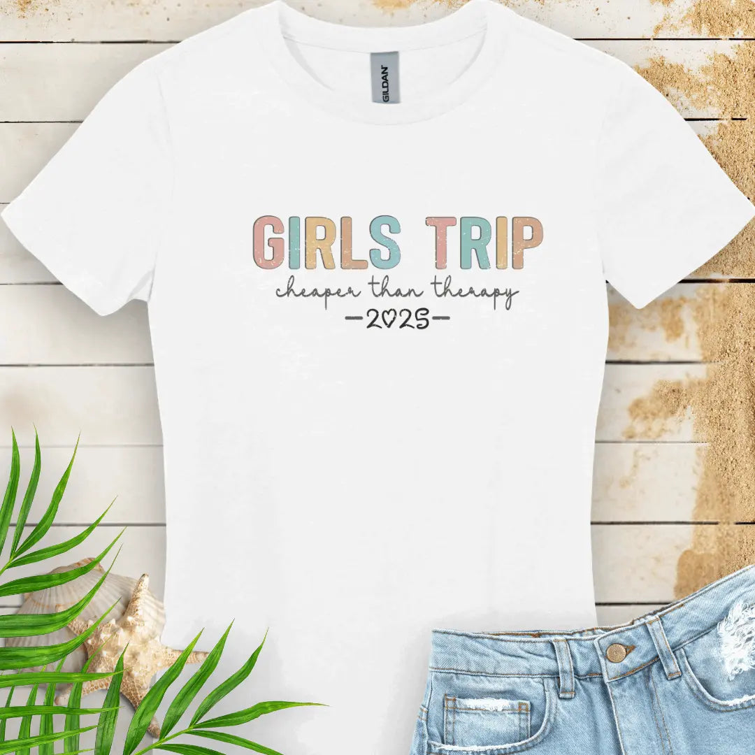 White Women's T-shirt featuring the phrase 'Girl’s Trip Cheaper Than Therapy' customized with the year. Made from soft, breathable fabric, this stylish and fun tee is perfect for group vacations, bachelorette parties, and beach getaways.