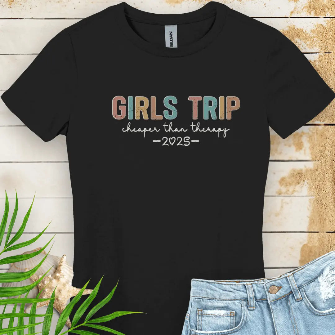 Black Women's T-shirt featuring the phrase 'Girl’s Trip Cheaper Than Therapy' customized with the year. Made from soft, breathable fabric, this stylish and fun tee is perfect for group vacations, bachelorette parties, and beach getaways.
