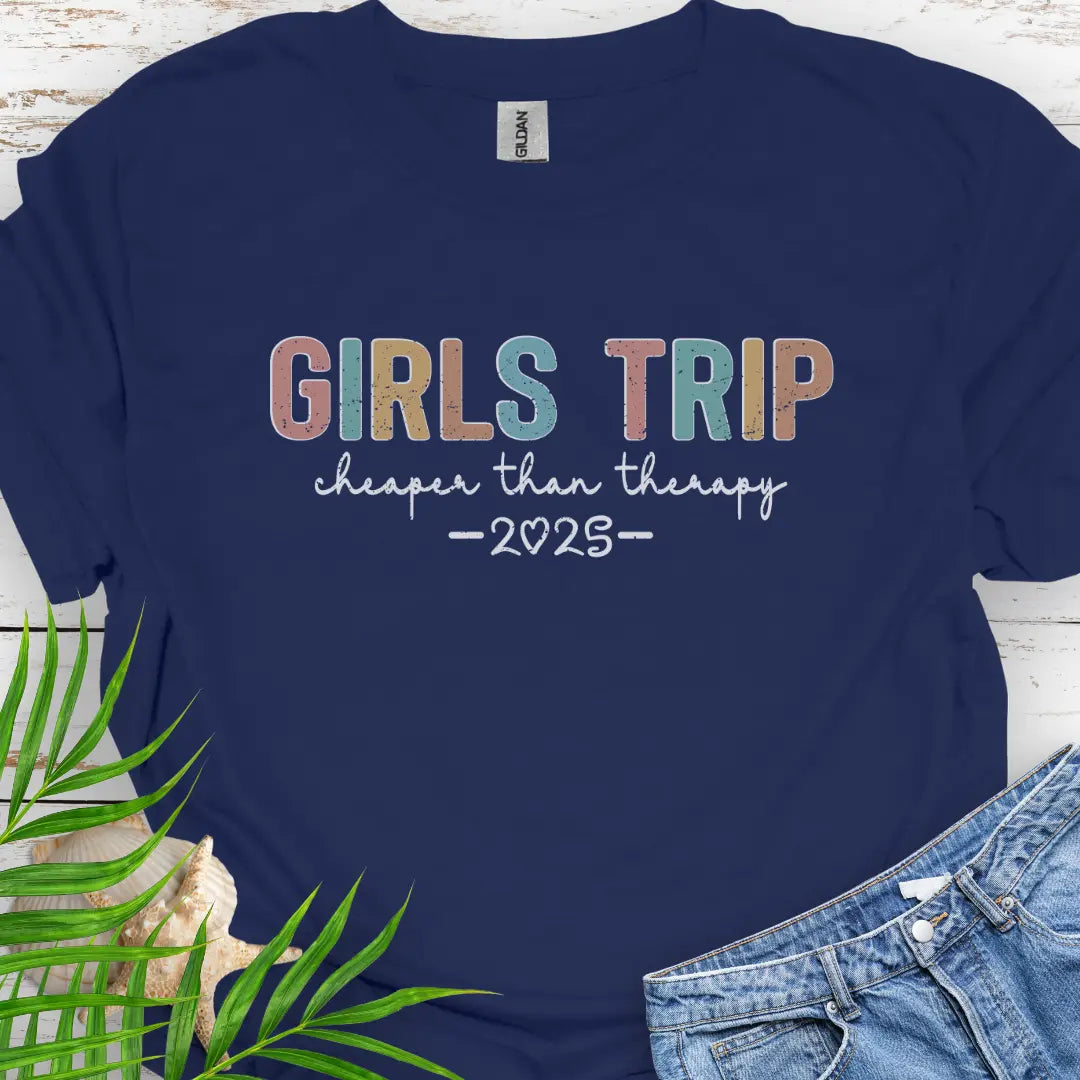 Navy Girl’s Trip T-shirt with colorful grunge text, "Cheaper Than Therapy," and a customizable year. Perfect for group trips, fun getaways, and lasting memories.