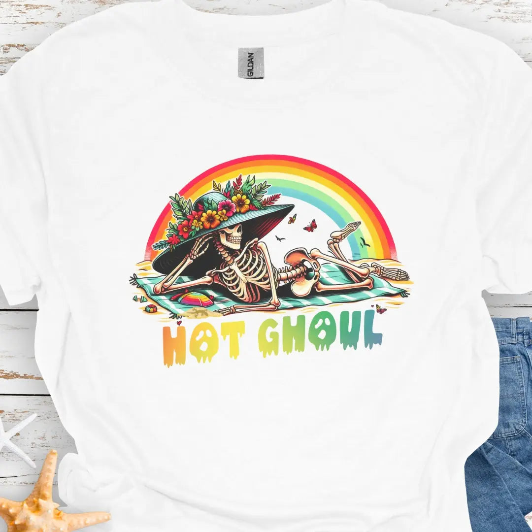 White t-shirt with a girl skeleton laying on beach towel with flowered hat and rainbow with rainbow dripping text that says Hot Ghoul.