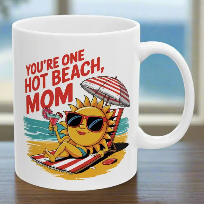 A white 11 oz mug with a sexy sun laying on a beach towel holding a drink on the beach that says You're One Hot Beach Mom.
