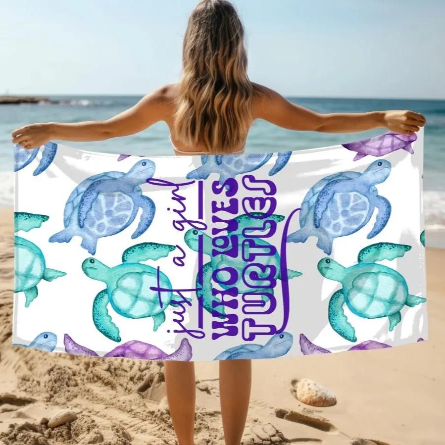 White beach towel with turquoise, blue and purple sea turtles that says Just a Girl Who Loves Sea turtles. The perfect beach towel for a Sea Turtle lover!