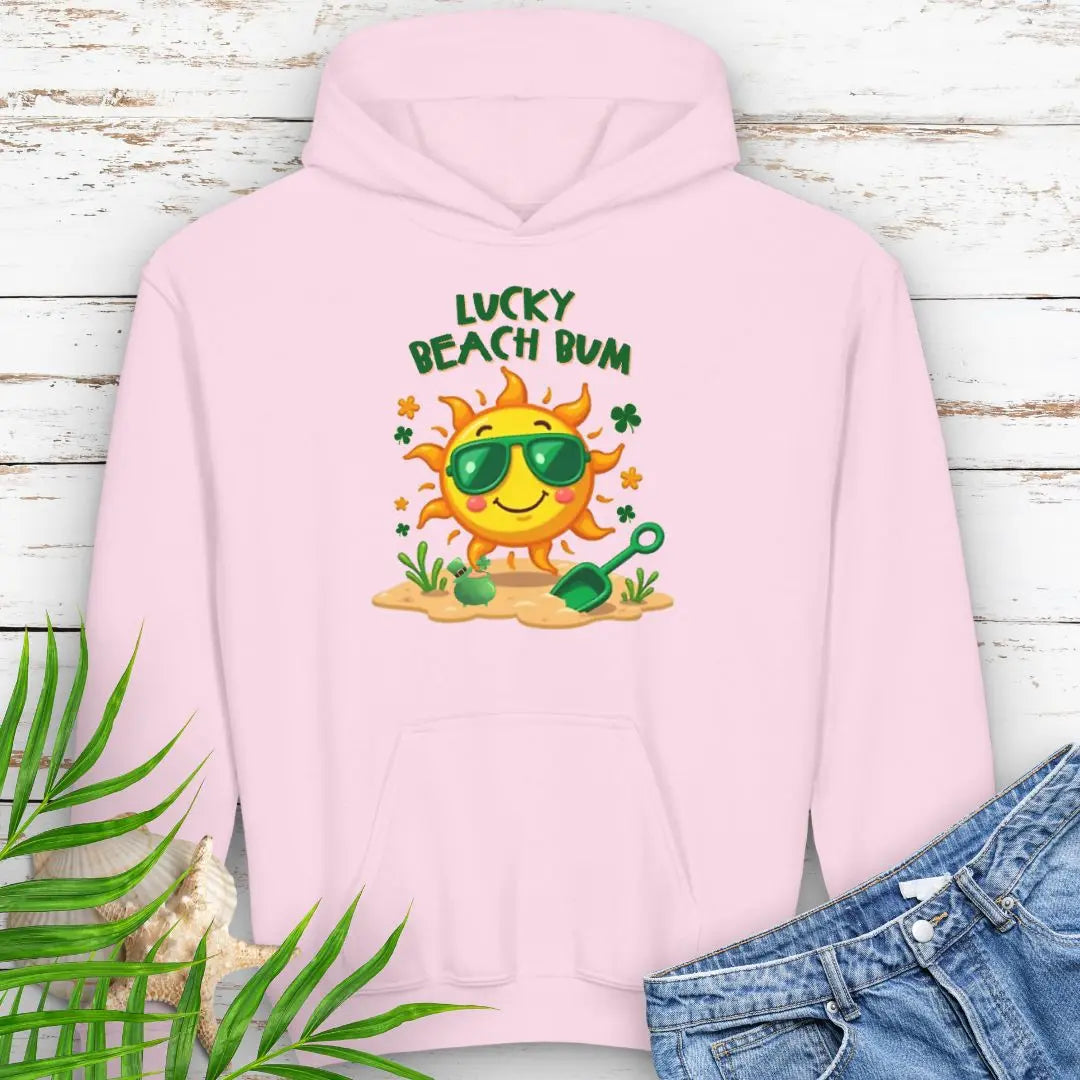 Lucky Beach Bum Child's Pink Hoodie with a smiling sun wearing green sunglasses on the beach with beach toys.