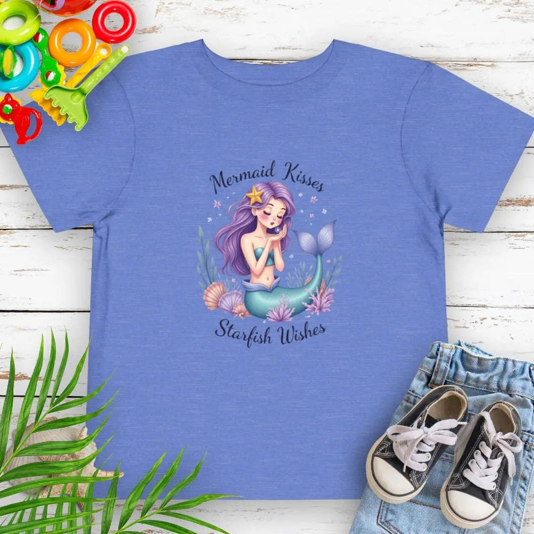Mermaid Kisses Starfish Wishes Toddler Heather Columbia Blue T-shirt featuring a mermaid sitting in sea plants and shells blowing bubbles.