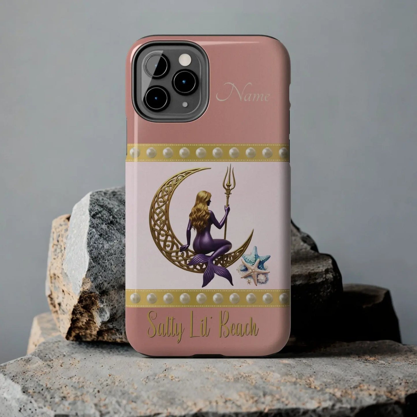 Pink and White 11 Pro iPhone Case with mermaid sitting on a celtic crescent moon holding a trident that says Salty Lil' Beach. Personalized with name.