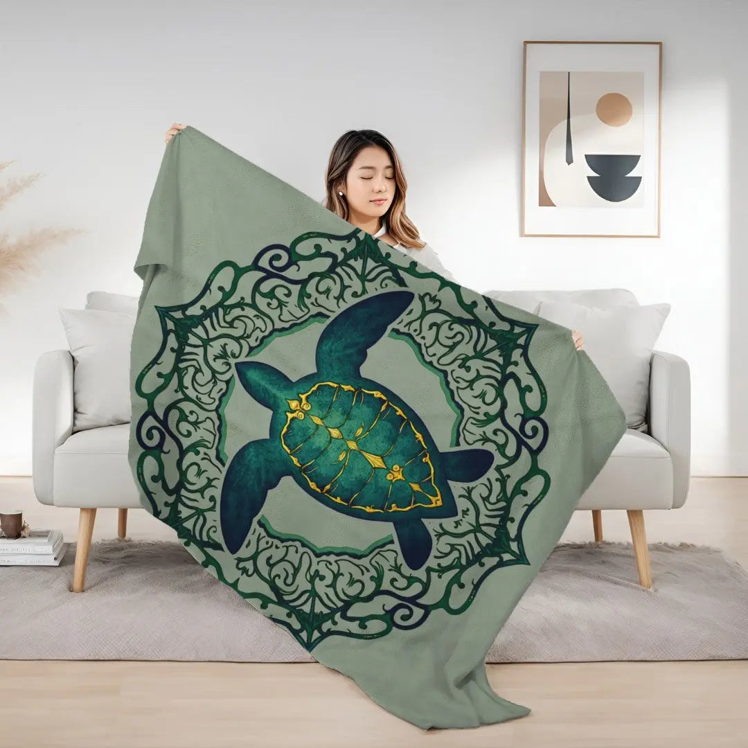 Our plush velveteen blanket in sage with a sea turtle and a fancy mandala frame in emerald green.