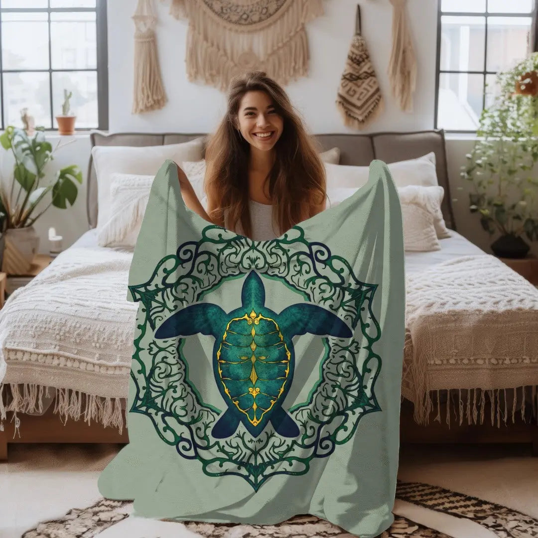 Our plush velveteen blanket in sage with a sea turtle and a fancy mandala frame in emerald green.