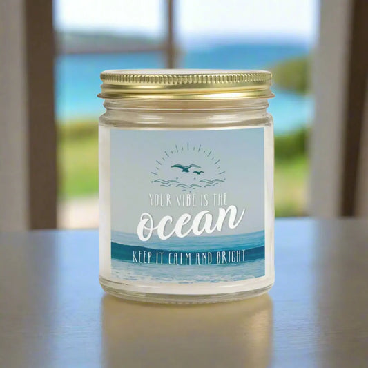 9 oz Clear Jar Scented candle featuring label with an ocean view with the inspirational phrase 'Your Vibe is the Ocean Keep it Calm and Bright,' making it the perfect addition to any nautical or coastal-themed home decor.