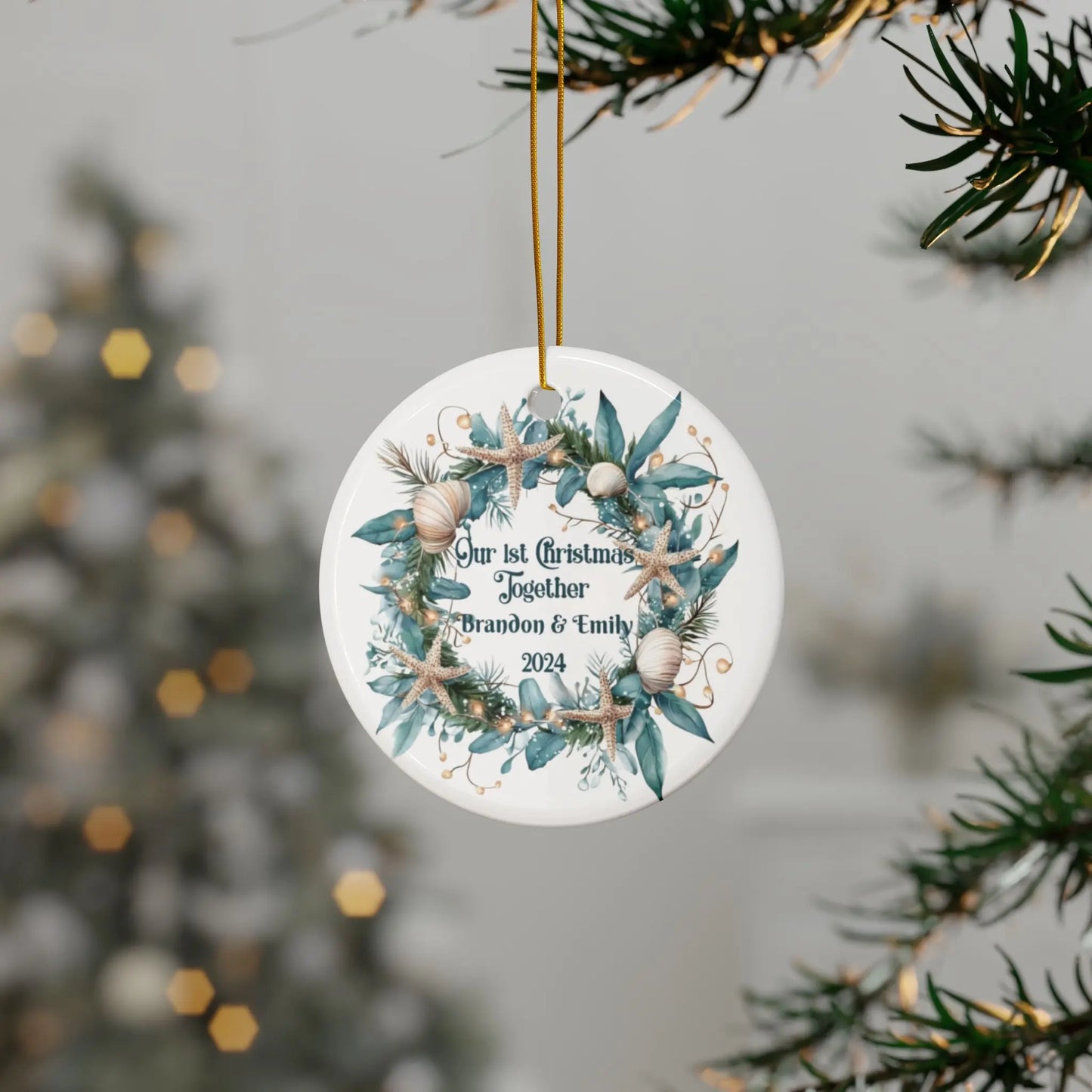 White round ornament featuring a beach-themed wreath with seashells and starfish, displaying "Our 1st Christmas Together." Personalized with names and year, this coastal holiday keepsake is perfect for celebrating a special first Christmas.