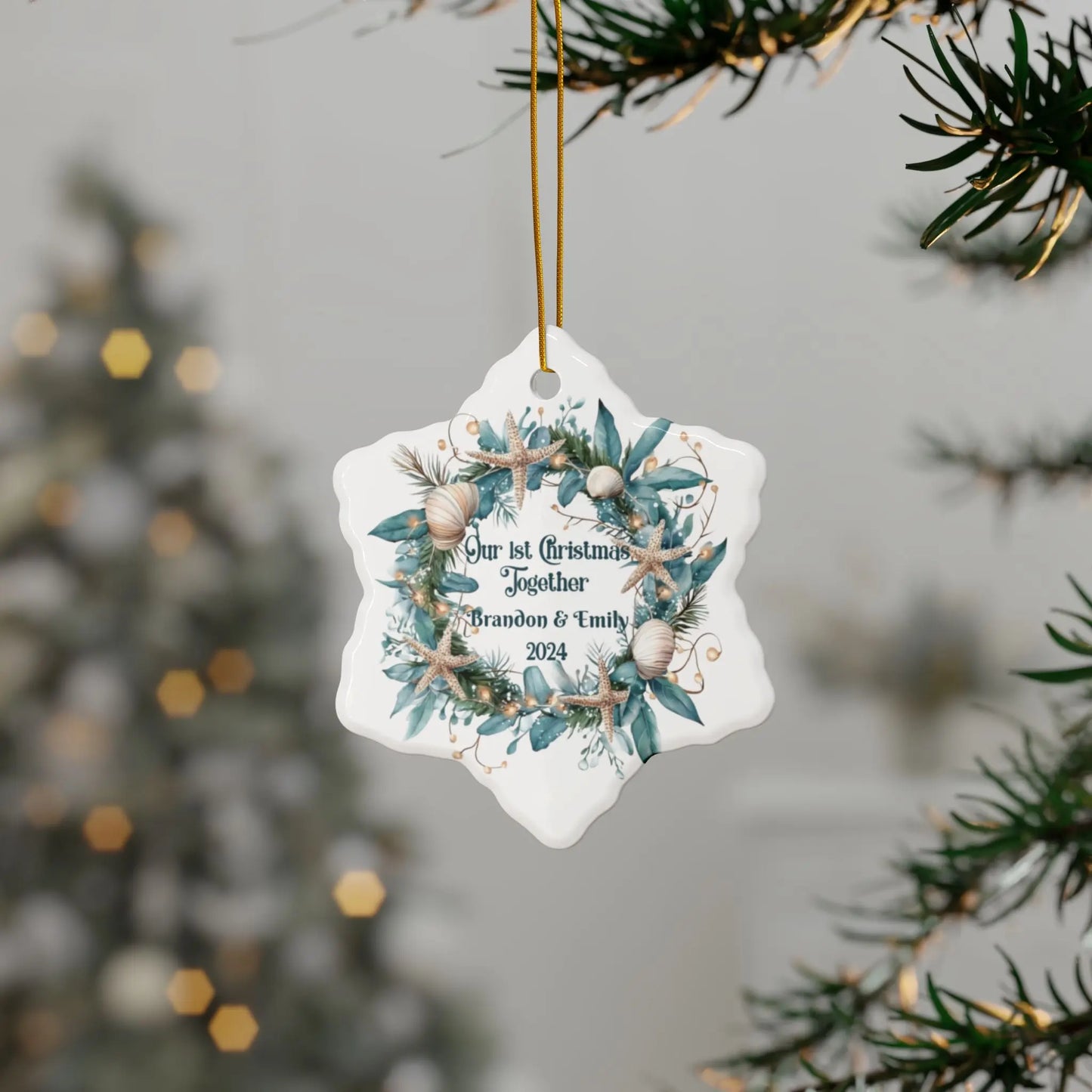 White snowflake ornament featuring a beach-themed wreath with seashells and starfish, displaying "Our 1st Christmas Together." Personalized with names and year, this coastal holiday keepsake is perfect for celebrating a special first Christmas.