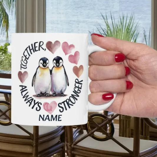 White 11 oz ceramic mug featuring two adorable penguins with hearts and the phrase 'Always Stronger Together.' A perfect gift for couples, friends, or family, this durable and microwave-safe mug is ideal for coffee, tea, or hot cocoa."