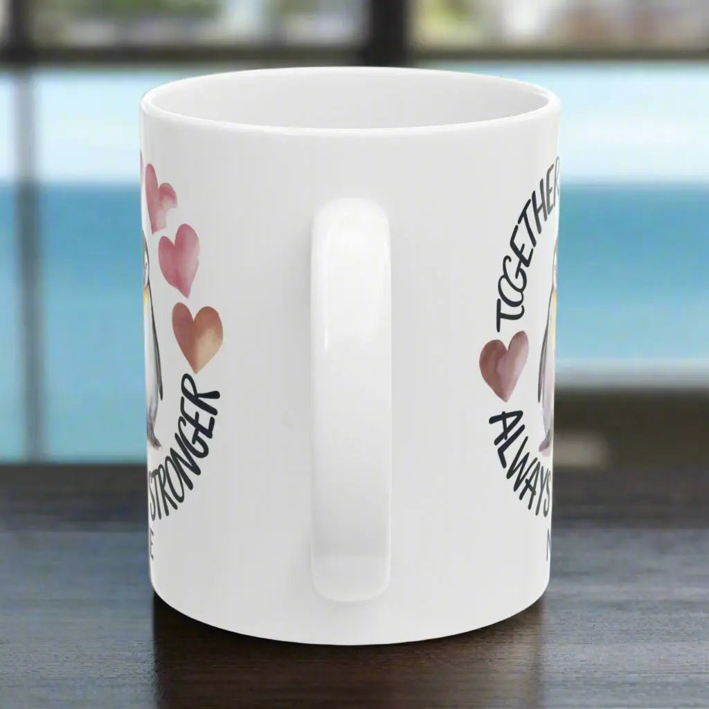 Side View of White 11 oz ceramic mug featuring two adorable penguins with hearts and the phrase 'Always Stronger Together.' A perfect gift for couples, friends, or family, this durable and microwave-safe mug is ideal for coffee, tea, or hot cocoa."
