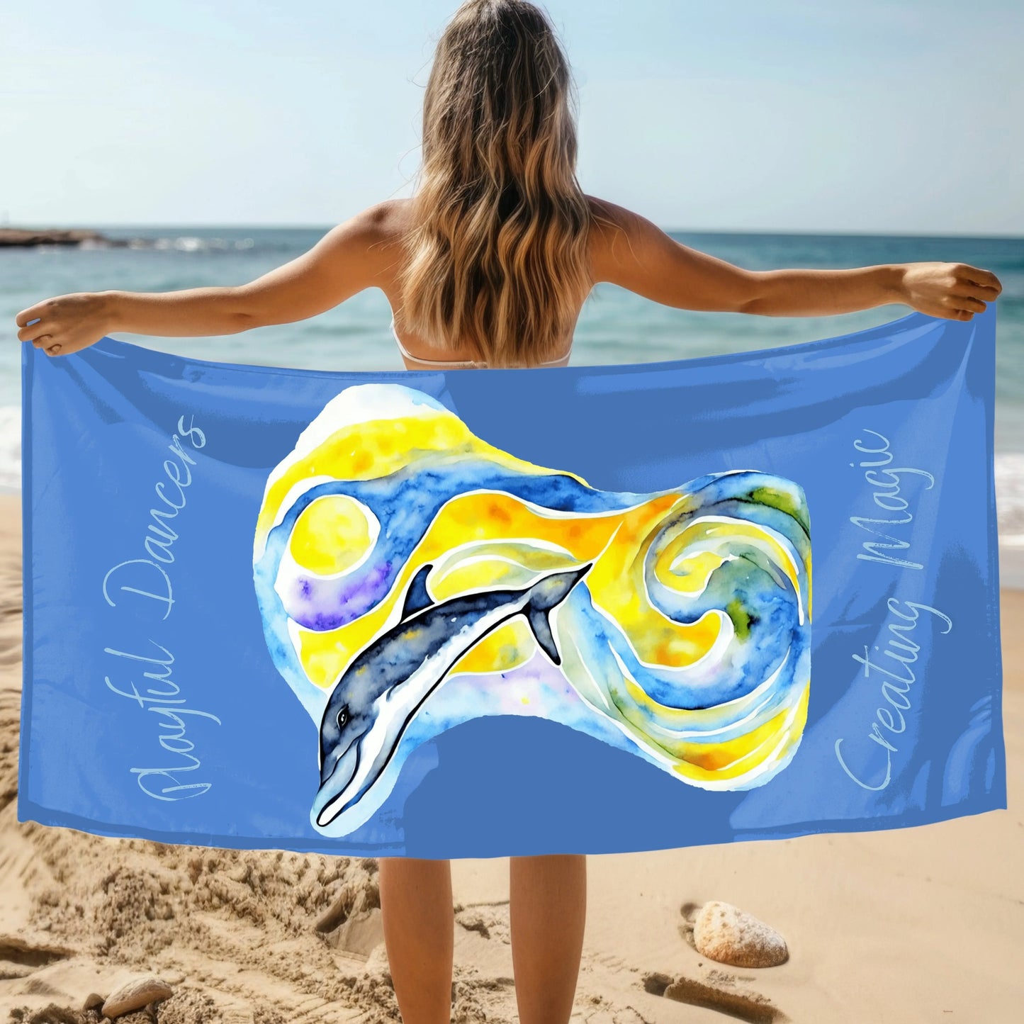 Blue beach towel with abstract dolphin image with yellow and blue background with the phrase Playful Dancers Creating Magic.