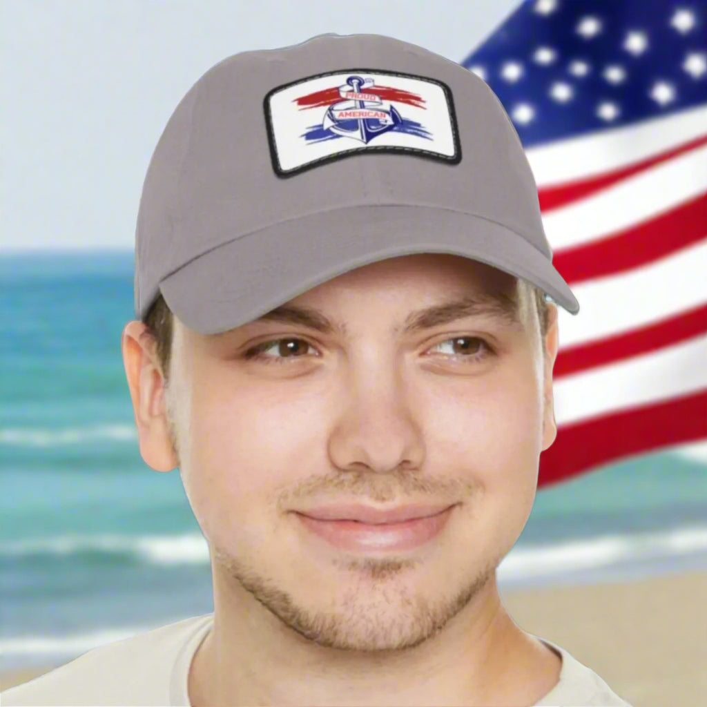 Gray Curved-bill hat with leather patch featuring an anchor design and the words “Proud American,” perfect for patriotic celebrations and everyday wear.