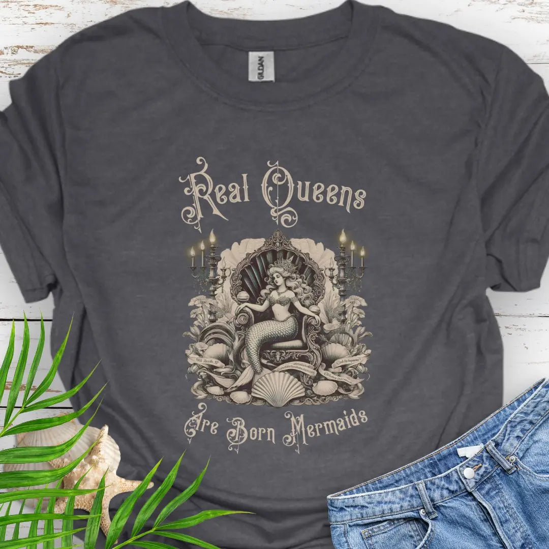Dark Heather T-shirt with mermaid in Victorian style chair and surrounding shells and candles with the text Real Queens Are Born Mermaids -perfect for those who believe in mermaid magic and want to showcase their inner queen.