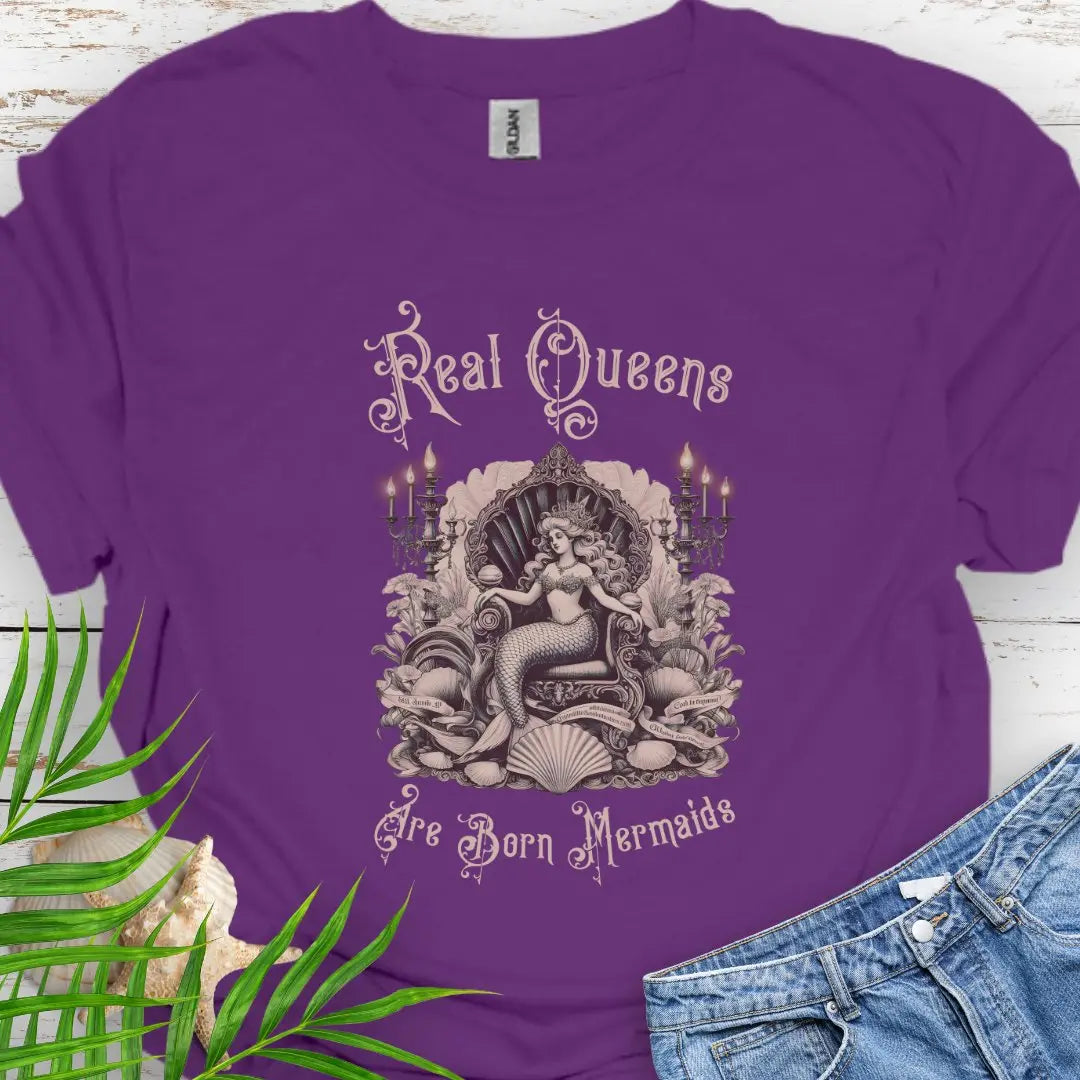 Purple T-shirt with mermaid in Victorian style chair and surrounding shells and candles with the text Real Queens Are Born Mermaids -perfect for those who believe in mermaid magic and want to showcase their inner queen.