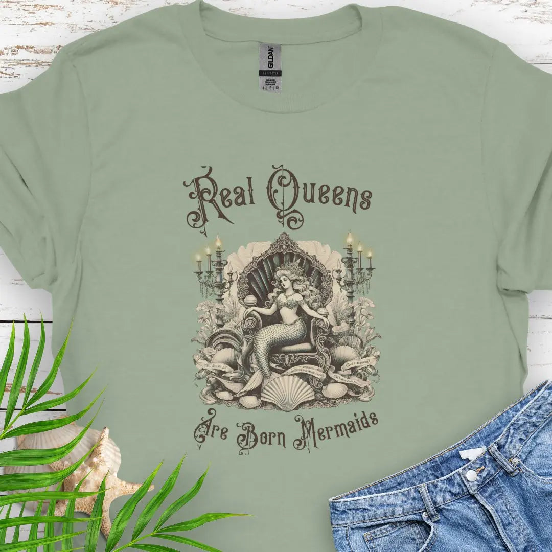 Sage T-shirt with mermaid in Victorian style chair and surrounding shells and candles with the text Real Queens Are Born Mermaids -perfect for those who believe in mermaid magic and want to showcase their inner queen.